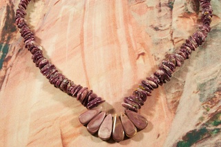 Beautiful Necklace featuring Genuine Purple Spiny Oyster Shell with Lion's Paw Pendant. Sterling Silver Beads and Clasp. Created by Santo Domingo Artist Lester Abeyta.The Santo Domingo Pueblo is in New Mexico, near Santa Fe. Lester Abeyta (Santo Domingo Pueblo) won first place in the Jewelry/Lapidary category at the IACA 2011 artist of the year awards. Lester is well known for his traditional stone and shell jewelry. His work is a reflection of the ancient techniques and styles of the Santo Domingo People, yet is fashionable in today's contemporary world. His parents, Richard and Delia Abeyta, taught Lester from an early age both the traditional and contemporary methods of lapidary art. All of his jewelry is hand made from raw materials utilizing both lapidary techniques.